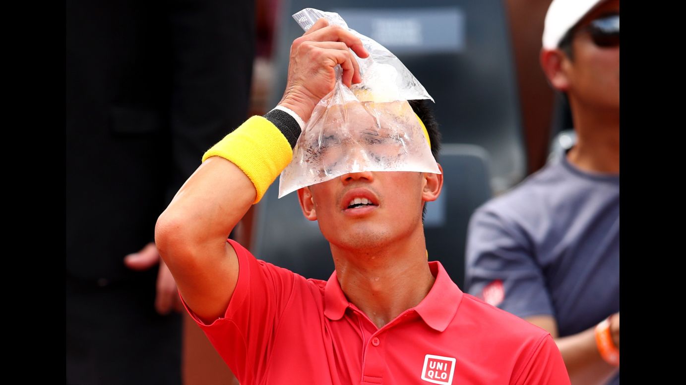 Kei Nishikori of Japan cools down with an ice bag during his men's singles first round match against Maxime Janvier of France during day one of the 2018 French Open at Roland Garros on Sunday, May 27, in Paris, France. 
