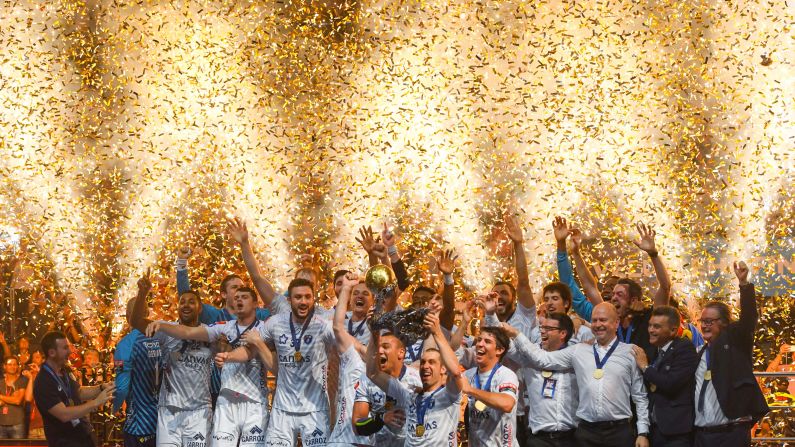 Montpellier's players celebrate with the trophy after winning the Final match HBC Nantes vs HB Montpellier at the EHF Pokal men's Champions League Final Four competition on Sunday, May 27, in Cologne, Germany.