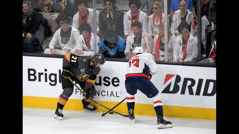 Vegas Golden Knights center William Karlsson (71) and Washington Capitals left wing Jakub Vrana (13) battle for the puck in front of a group of fans dressed as Elvis in the first period in game one of the 2018 Stanley Cup Final on Monday, May 28 in Las Vegas. 