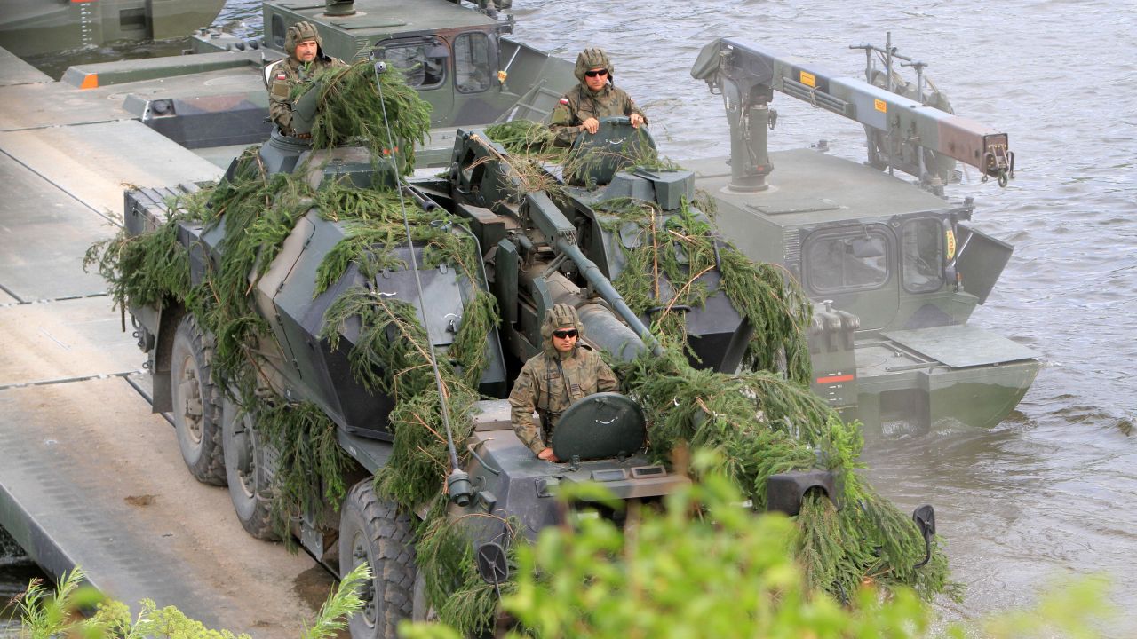 NATO advance force battalion group (EFP) demonstrates a water obstacle crossing during an International exercise "Iron Wolf 2017 /Saber Strike 2017' in Stasenai on June 20, 2017.   
The multinational Exercise Iron Wolf 2017 as part of the Exercise Saber Strike 2017 is running in Lithuania on June 12-23 and involves over 5 thousand troops from 10 NATO allies. / AFP PHOTO / Petras Malukas        (Photo credit should read PETRAS MALUKAS/AFP/Getty Images)