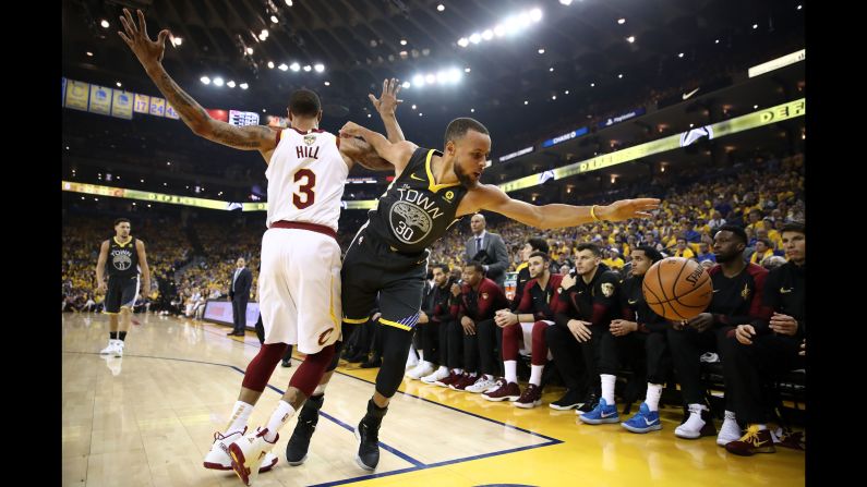 Curry tries to save a ball from going out of bounds in Game 2.