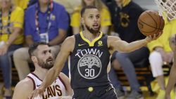 Golden State Warriors guard Stephen Curry (30) shoots against Cleveland Cavaliers forward Kevin Love (0) during the first half of Game 2 of basketball's NBA Finals in Oakland, Calif., Sunday, June 3, 2018. (AP Photo/Marcio Jose Sanchez)