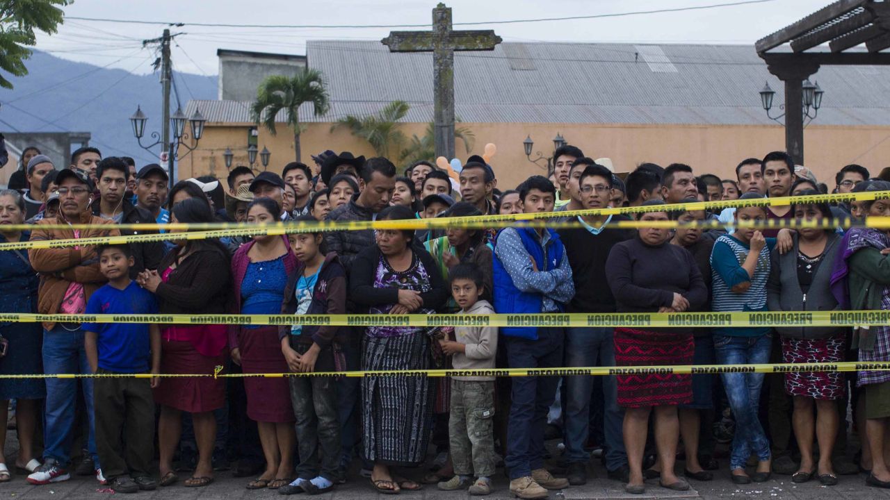 Neighbors stand outside a temporary morgue near Volcan de Fuego in Alotenango, Guatemala.