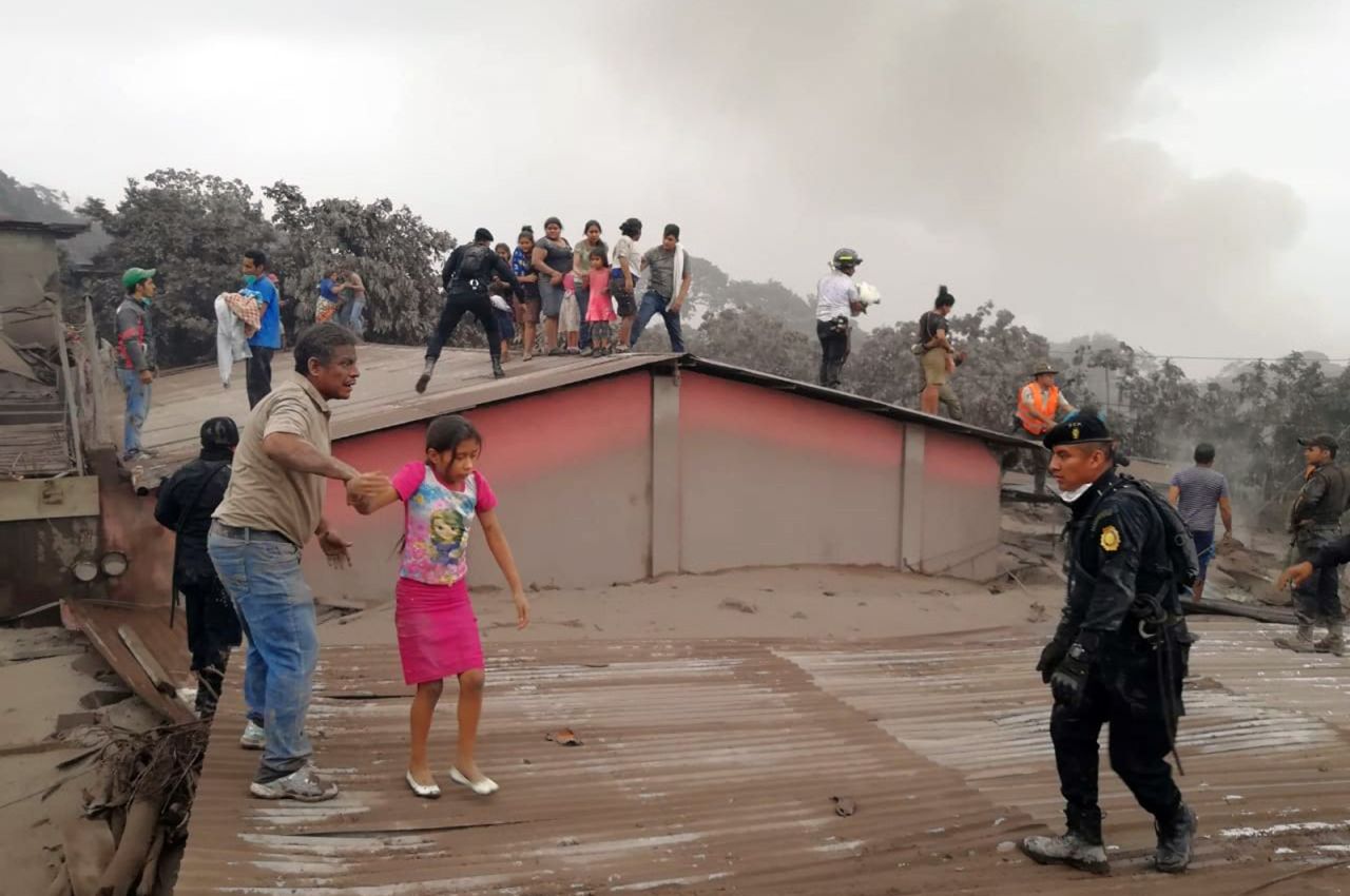 Rescue workers evacuate a house in Acatenango on June 3.