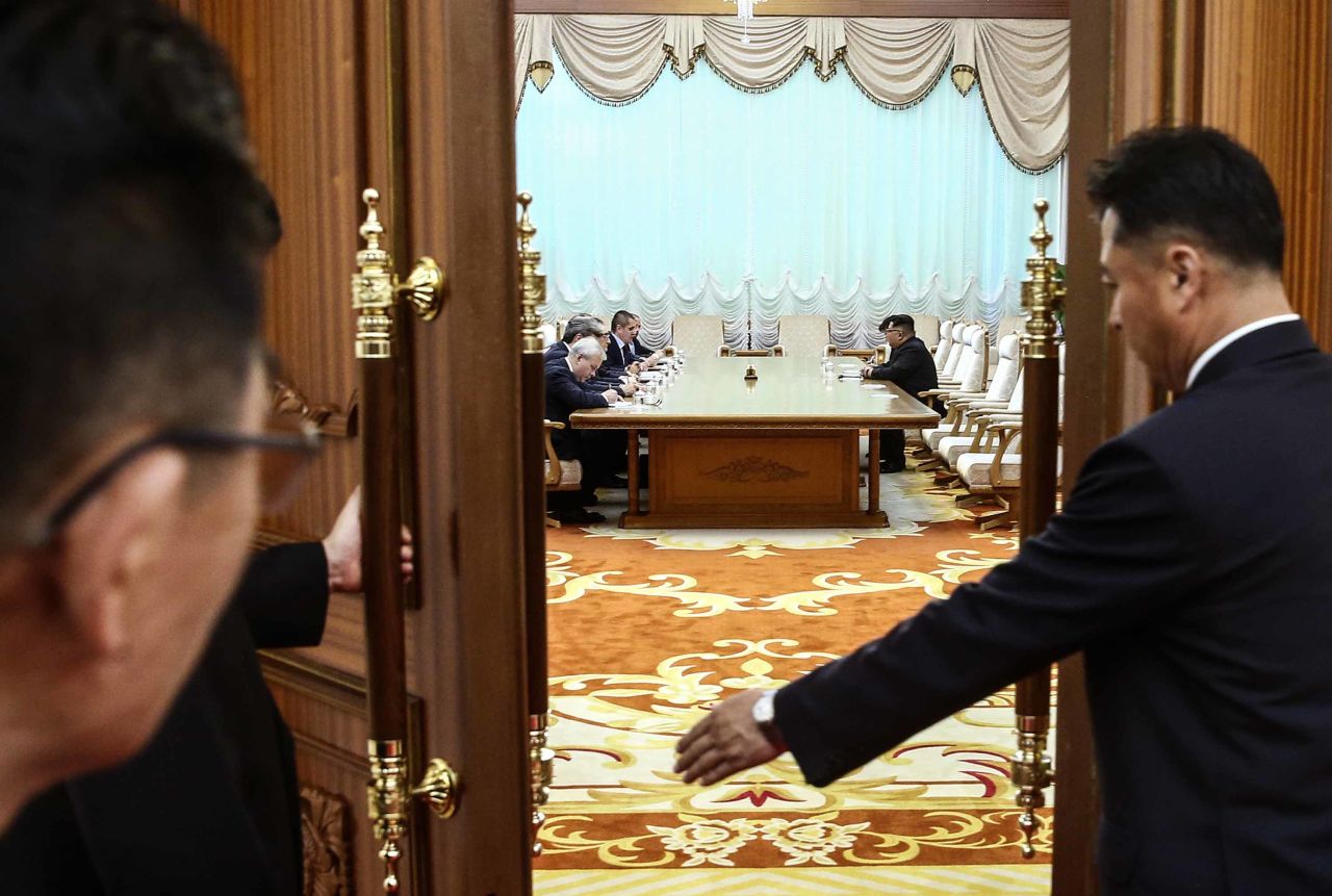 Lavrov and Kim's meeting is seen through a doorway at the Palace.