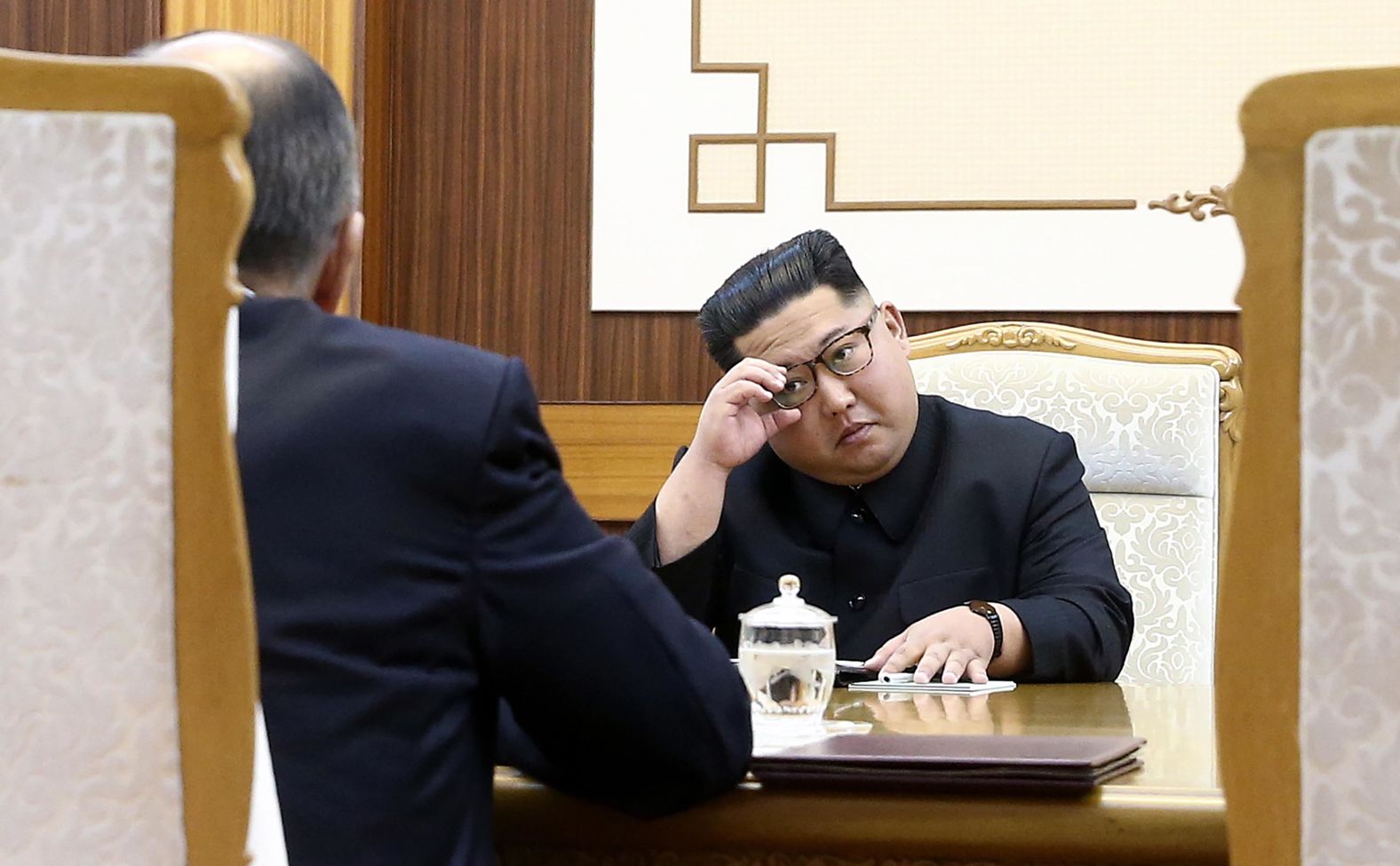 Kim adjusts his glasses during a meeting with Lavrov.