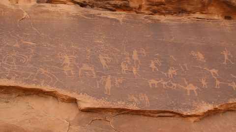 Other rock faces feature engraved art. In this scene ibex -- a type of wild goat -- are being hunted with bows and arrows.