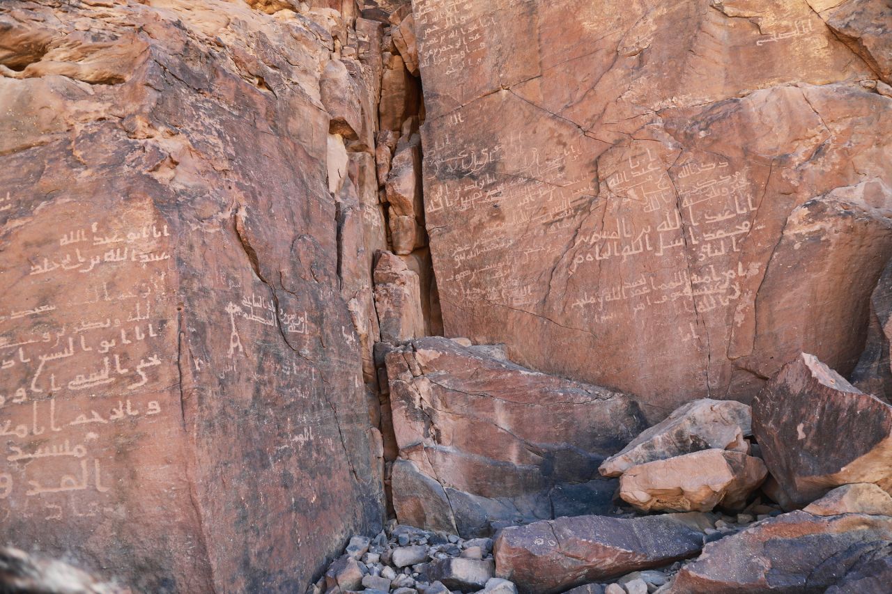 Some of Al-Ula's rocks and cliff faces are adorned with inscriptions written in a number of languages including Arabic (seen here), Aramaic, Nabataean, Greek and Latin.<br />