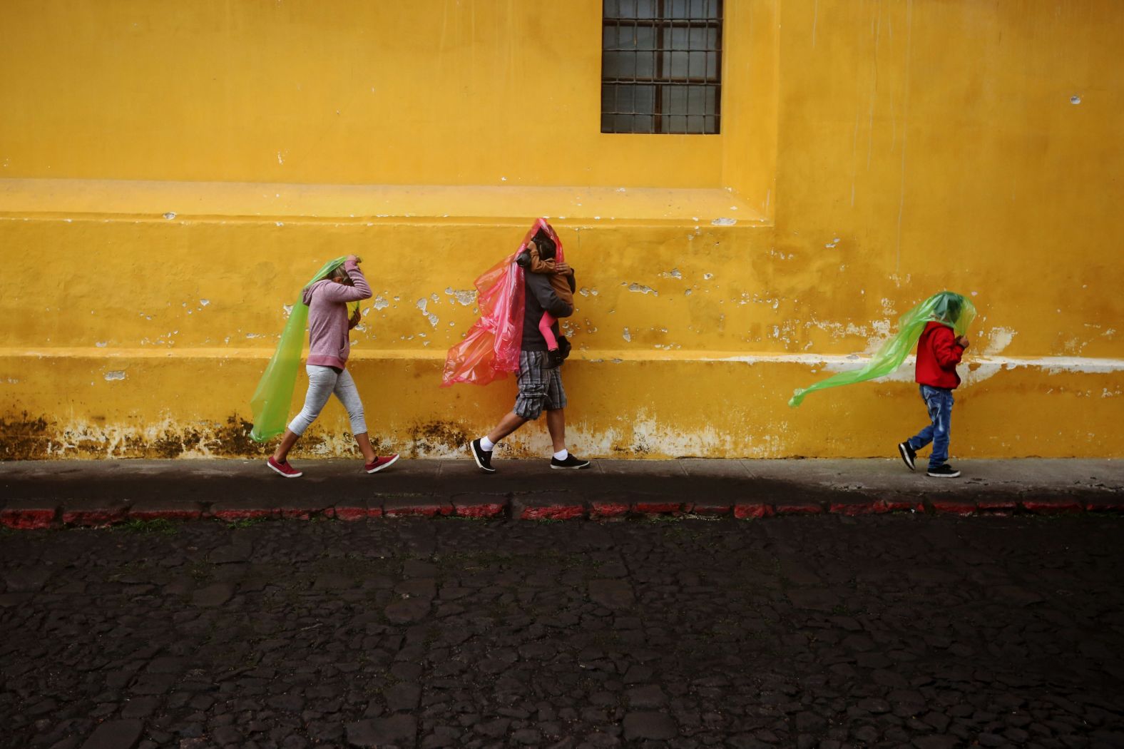 People cover themselves to avoid ash in Antigua.