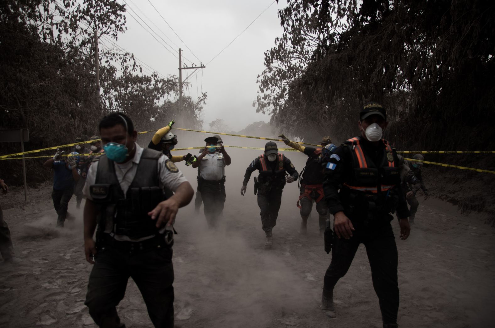 Police officers help people evacuate El Porvenir on June 3.