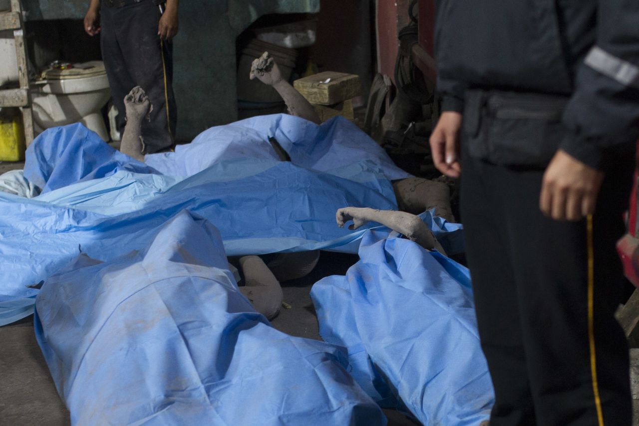 Bodies are laid in a temporary morgue in Alotenango.