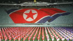 PYONGYANG, NORTH KOREA - OCTOBER 6: North Koreans perform showing North Korean national flag during the Arirang festival which is a part of commemorations marking the 60th anniversary of the Workers' Party of North Korea on October 6, 2005 in PyongYang, North Korea. The 60th anniversary of North Korea?s ruling, Korean Workers Party is being commemorated with a cultural and art festival and a nation wide celebration on October 10. The celebrations come amid uncertainties in the breakthrough agreement over North Korea?s nuclear programs.  (Photo by Chung Sung-Jun/Getty Images)