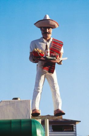La Salsa man, on the Pacific Coast Highway, Malibu, 1988. "There's a lot of giant men in Los Angeles. This one was great because originally he was a hamburger salesman. He had a white hat on and a hamburger on a plate and then it was sold to new owners who made into a Mexican restaurant, so it was changed into a sombrero and a taco."