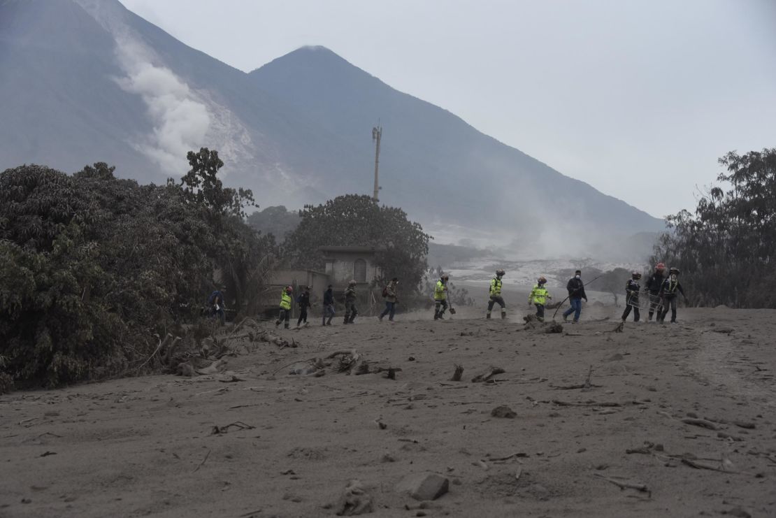 Rescuers search for victims in San Miguel Los Lotes, a village in Escuintla Department, about 35 kilometers southwest of Guatemala City.