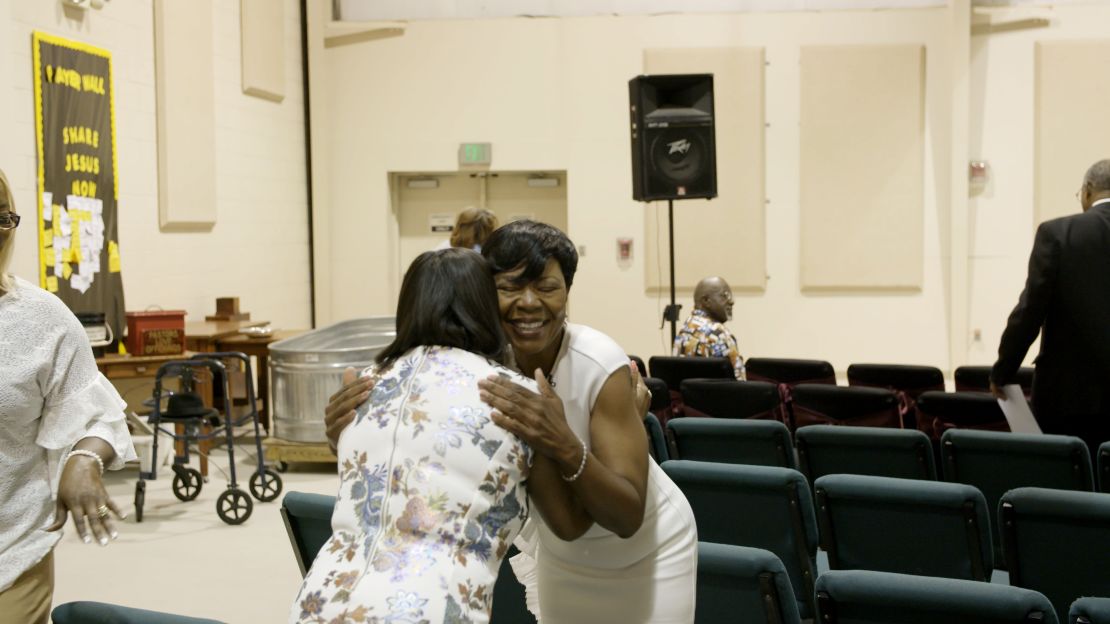 Jameria Moore hugs a woman in Hopewell Baptist Church in Birmingham, Alabama on Sunday, June 3.