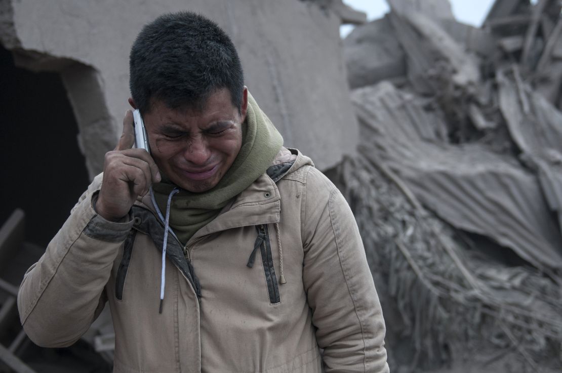Boris Rodriguez, 24, who is searching for his wife, cries after seeing the condition of his neighborhood, destroyed by the erupting Volcan de Fuego.