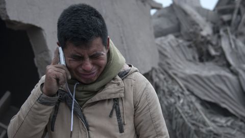 Boris Rodriguez, 24, who is searching for his wife, cries after seeing the condition of his neighborhood, destroyed by the erupting Volcan de Fuego.