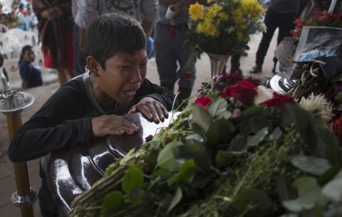 A young mourner cries over the coffin of 17-year-old Nery Otoniel Gomez Rivas, whose body was pulled from volcanic ash in Alotenango.