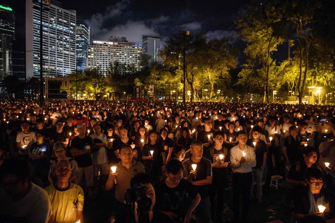 People hold candles during a vigil in Hong Kong on June 4, 2018.
