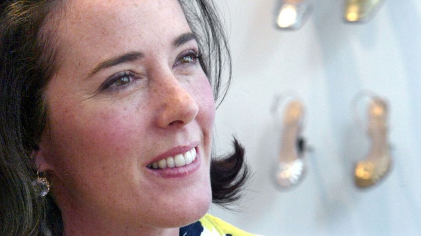 FILE - In this May 13, 2004 file photo, designer Kate Spade poses with shoes from her next collection in New York. Law enforcement officials say Tuesday, June 5, 2018, that New York fashion designer Kate Spade has been found dead in her apartment in an apparent suicide. (AP Photo/Bebeto Matthews, File)