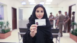 Esraa Albuti, an Executive Director at Ernst & Young, smiles as she brandishes her brand new driving licences issued Monday June 4 by the Kingdom of Saudi Arabia. 