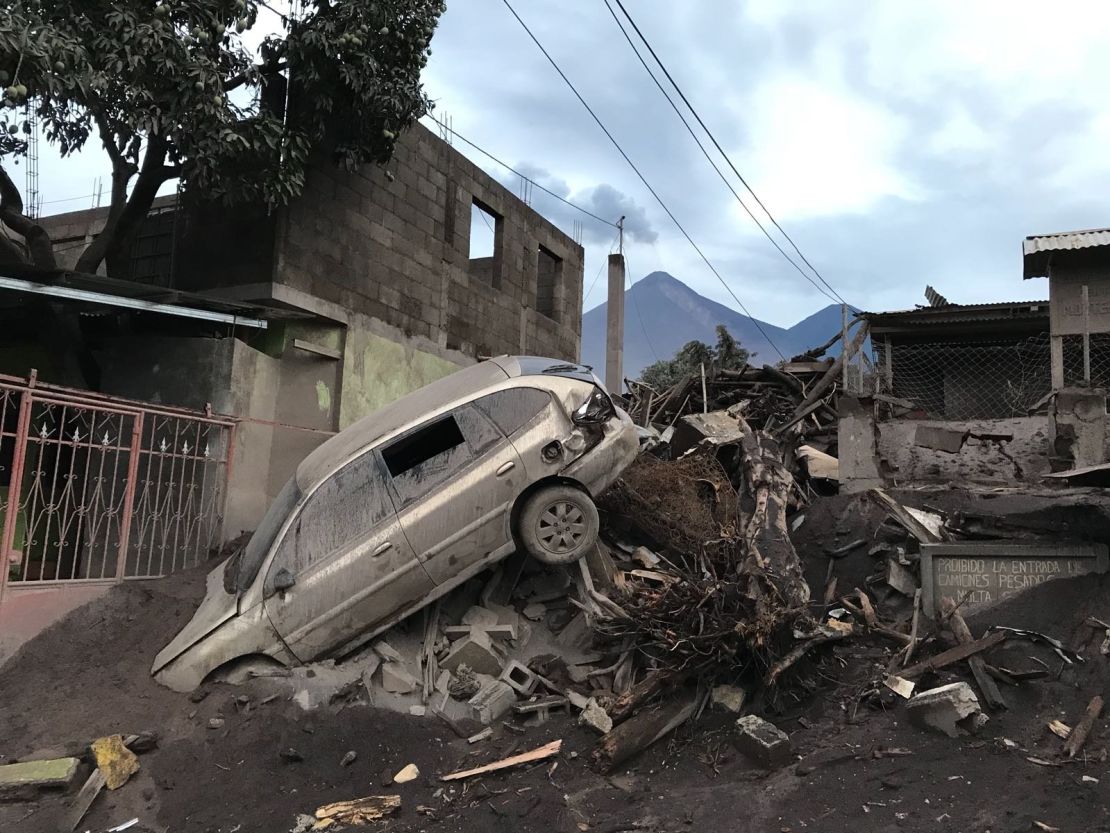 An abandoned car rests atop debris Wednesday in El Rodeo, Guatemala, after the volcano's eruption.