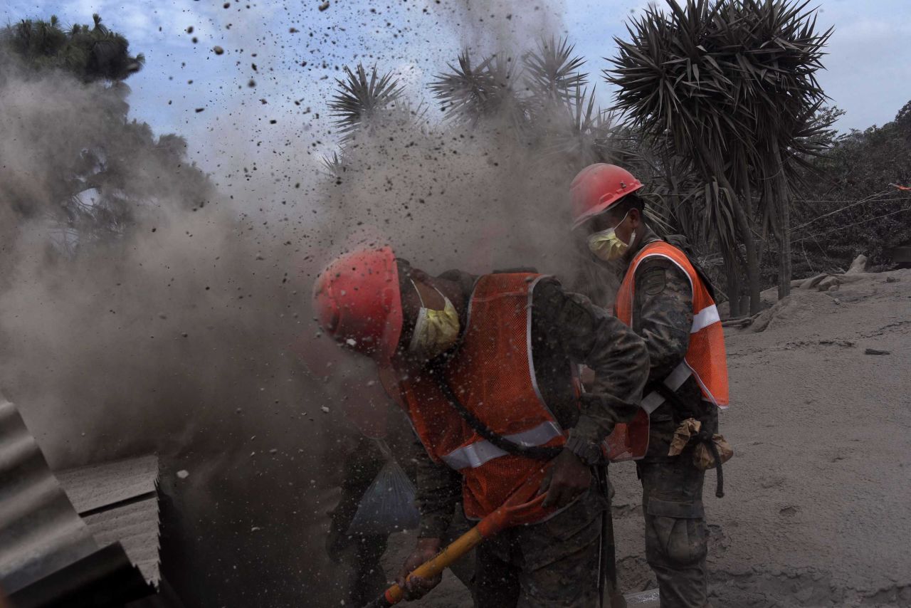 Members of the Guatemalan Army search for volcano victims in the ash-covered village of San Miguel Los Lotes.