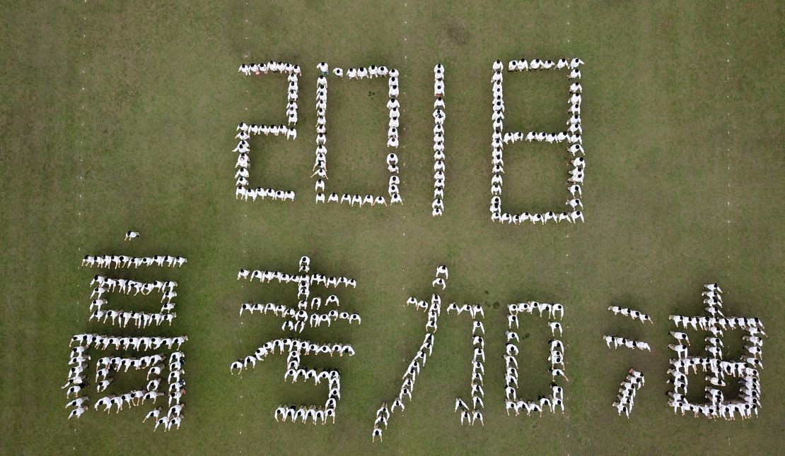 Aerial view of senior students of Hanjiang High School of Jiangsu Province posing as Chinese characters "2018 Gaokao Come On" during stress relief event ahead of the annual national college entrance examination.