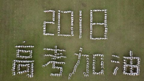 Aerial view of senior students of Hanjiang High School of Jiangsu Province posing as Chinese characters "2018 Gaokao Come On" during stress relief event ahead of the annual national college entrance examination.