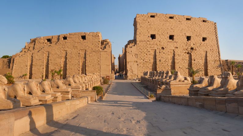 Don't limit yourself to one temple when visiting Egypt. A long promenade connects the temple at Luxor with the Karnak temple complex. Across the Nile are the royal tombs -- including the tomb of Tutankhamen -- in the Valley of the Kings. Tourists are shown here near statues inside Luxor Temple.