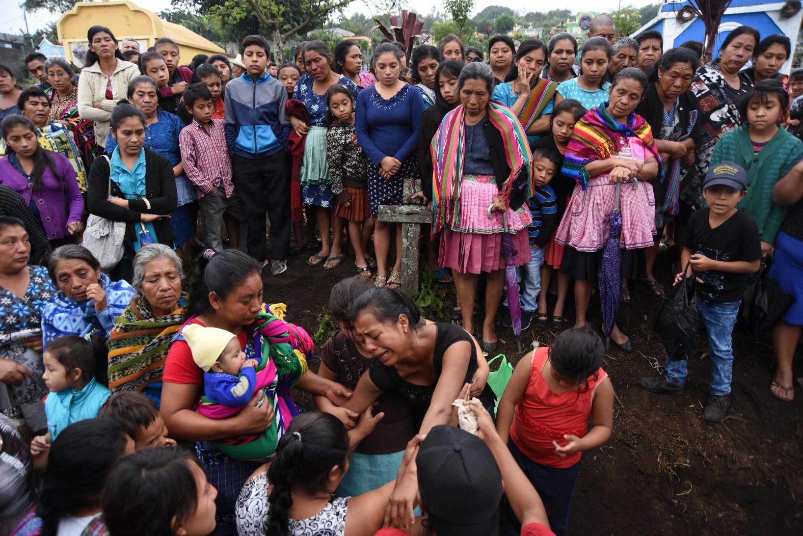 Relatives of 20-year-old victim Erick Rivas mourn his death during his funeral in Alotenango on June 6.