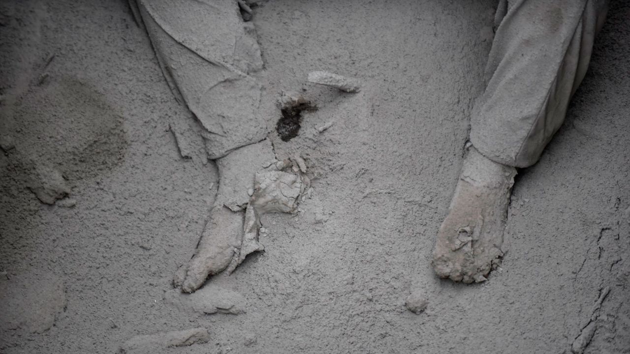 A body is covered in volcanic ash in the Guatemalan village of San Miguel Los Lotes on Monday, June 4. <a href="https://www.cnn.com/2018/06/03/americas/gallery/guatemala-volcano/index.html" target="_blank">See more photos from the Fuego volcano and its aftermath</a>