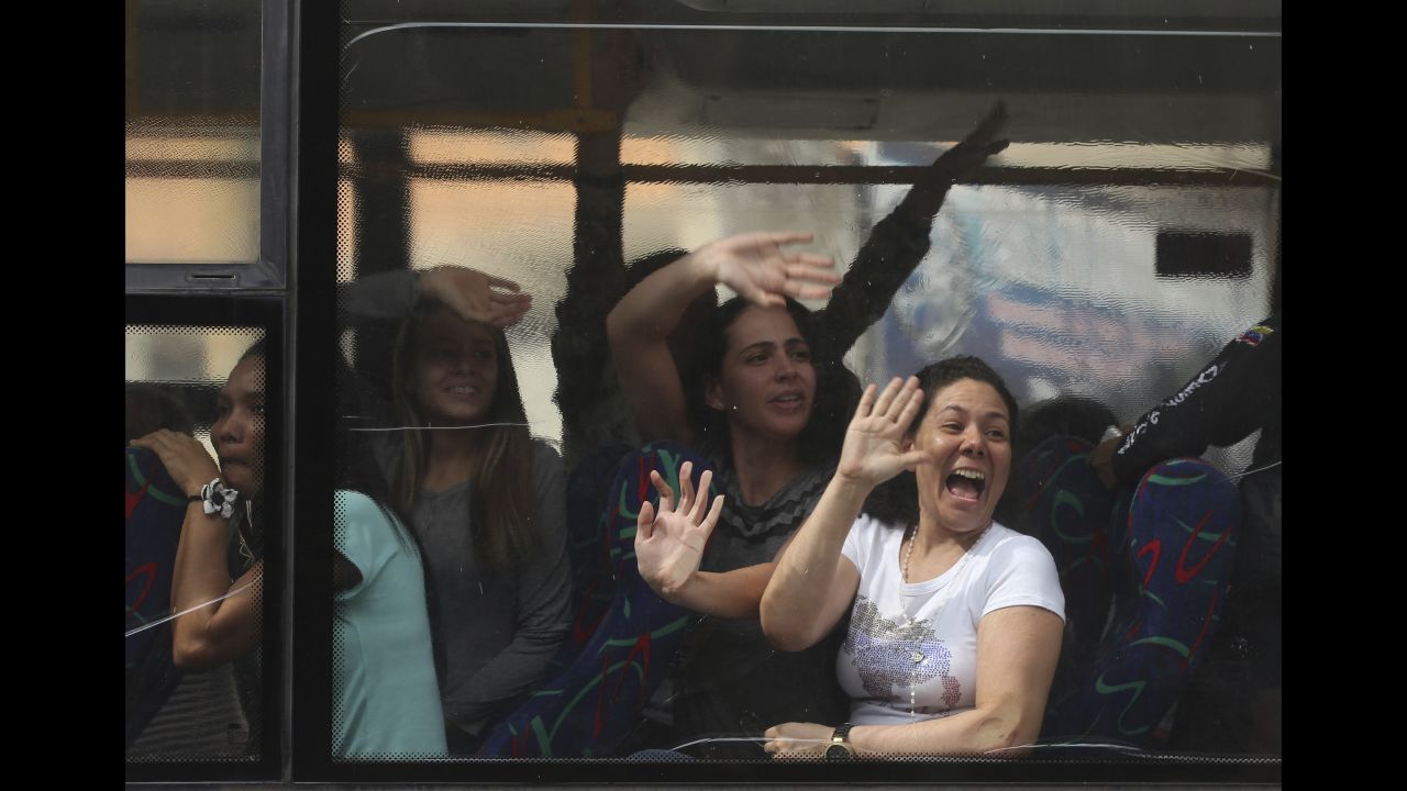 People wave prior to their release from the Helicoide prison in Caracas, Venezuela, on Friday, June 1. In a gesture aimed at uniting the fractured nation, Venezuelan officials released 39 jailed activists who government opponents consider to be political prisoners.