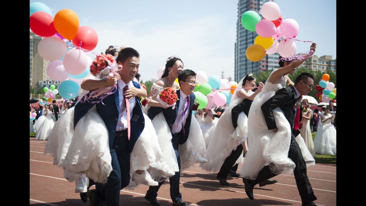 Newlywed couples play a game after a mass wedding ceremony at China's Harbin Institute of Technology on Saturday, June 2.