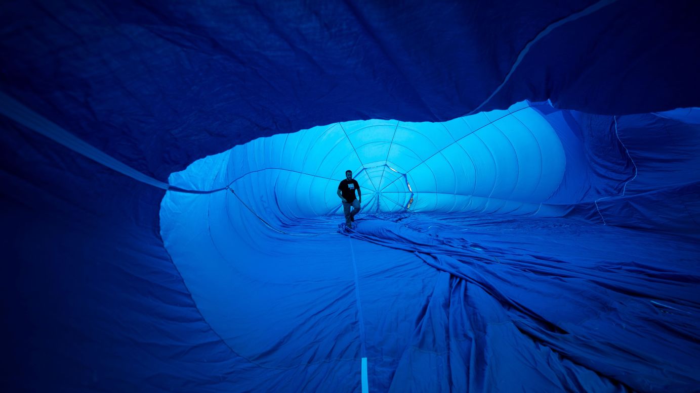 Pilot Hugo Varela walks inside his hot-air balloon as it inflates in Gijon, Spain, on Saturday, June 2.