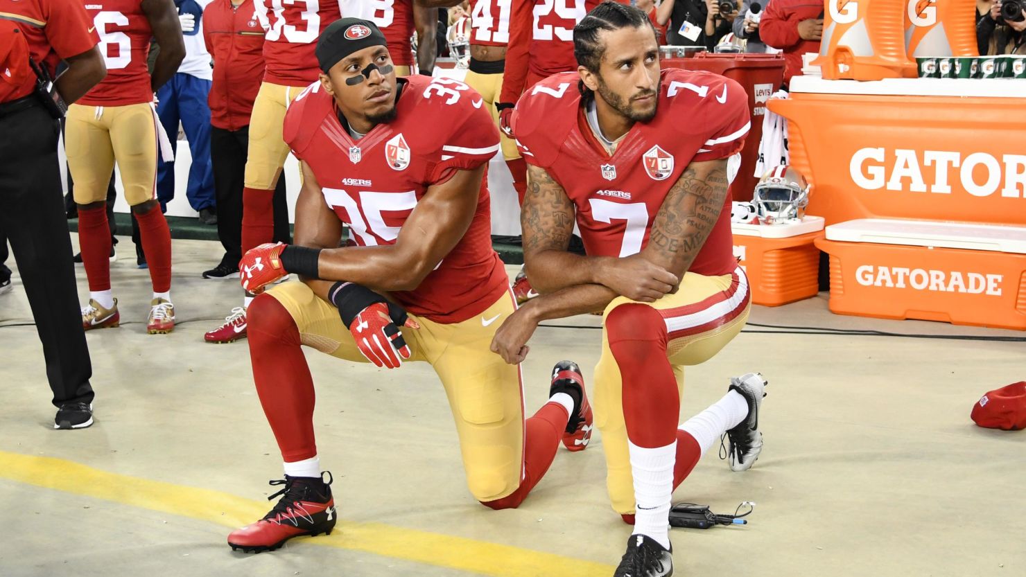 Eric Reid, left, and Colin Kaepernick of the San Francisco 49ers kneel during the National Anthem before an NFL game on September 12, 2016, at Levi's Stadium in Santa Clara, California.