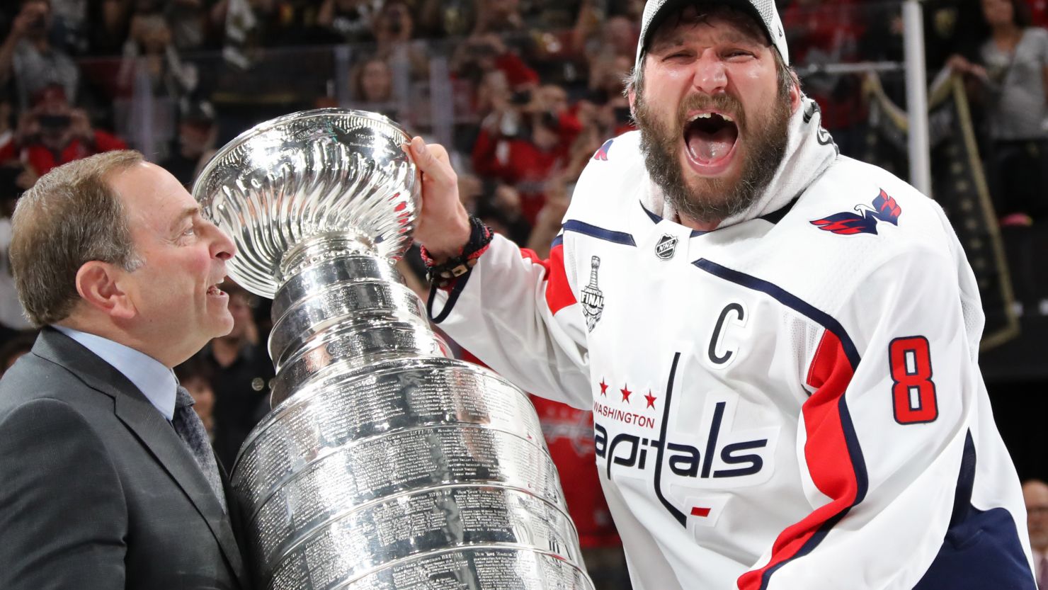 Alex Ovechkin is presented the Stanley Cup by NHL Commissioner Gary Bettman after his team defeated the Vegas Golden Knights 4-3 in Game 5.