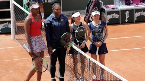 Venus and Serena Williams stand together at the 2018 French Open.