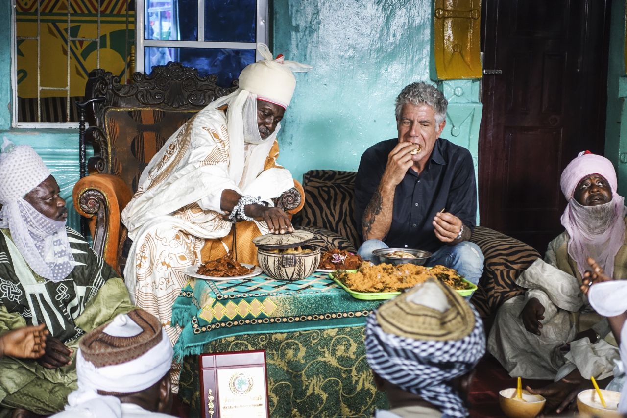 Bourdain sits down for lunch with Hausa people in Lagos, Nigeria, in 2017. "People open up to him and, in doing so, often reveal more about their hometowns or homelands than a traditional reporter could hope to document," said judges for the Peabody Award, who honored Bourdain in 2013.