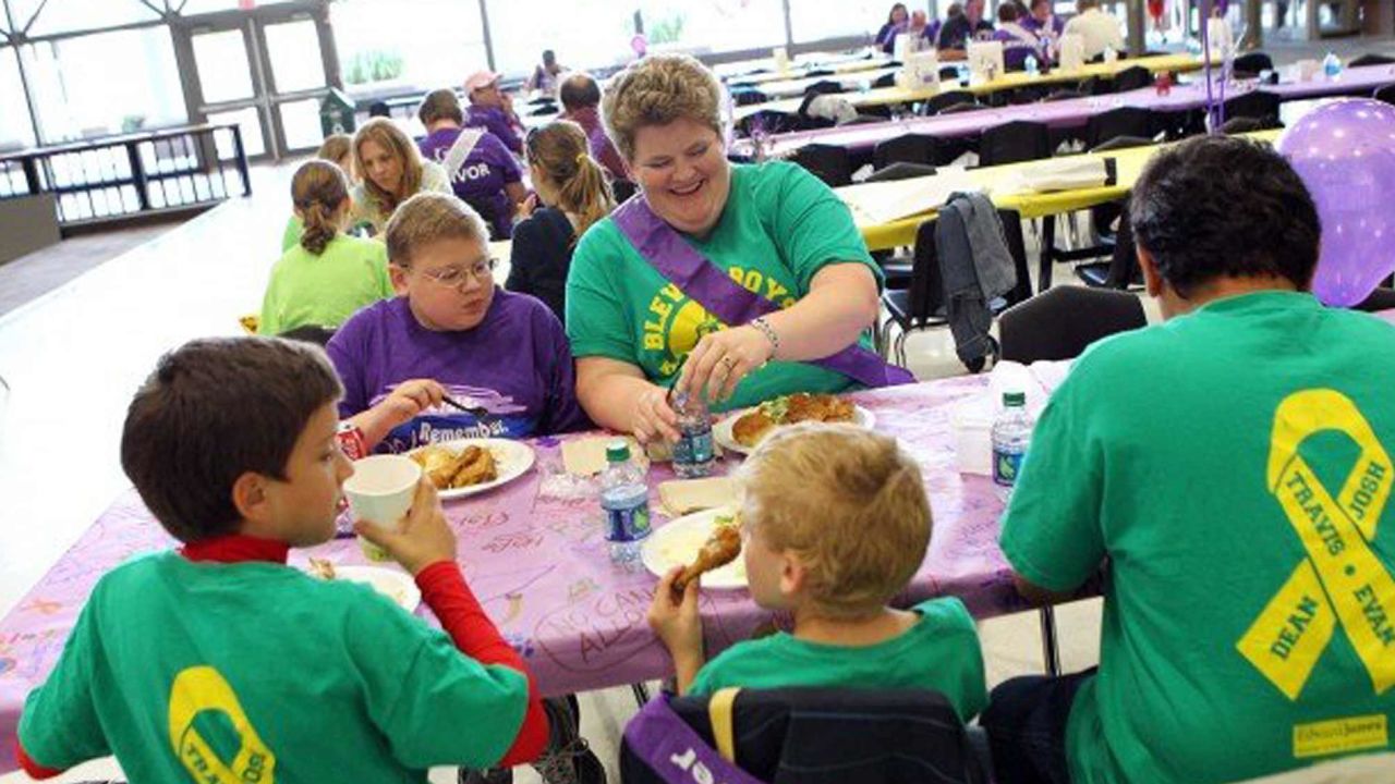Evan Piña-White, in the purple shirt, sits next his mom, Mary, in this 2012 photo.