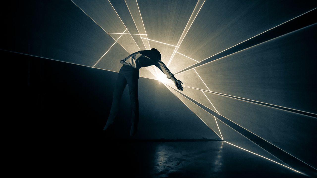 The performance used motion-tracking technology to project visuals that interact with the performers' movements in real-time.