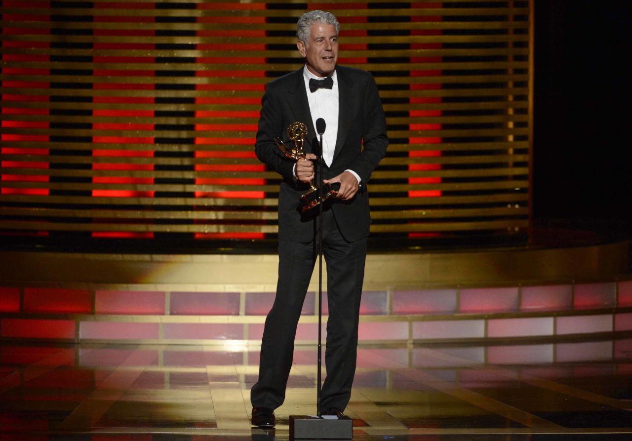 Bourdain accepts an Emmy Award for "Parts Unknown" in 2014.