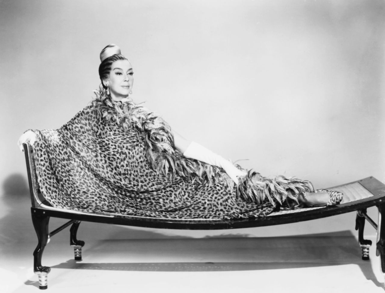Rosalind Russell wears a silk Galanos gown in a promotional shot for "Oh Dad, Poor Dad, Mamma's Hung You in the Closet and I'm Feelin' So Sad" in 1967.