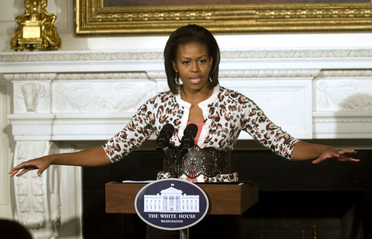 Michelle Obama wears a leopard cardigan at a public appearance in 2009.