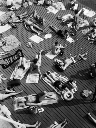 Sunbathers pictured at Deligny pool in Paris.