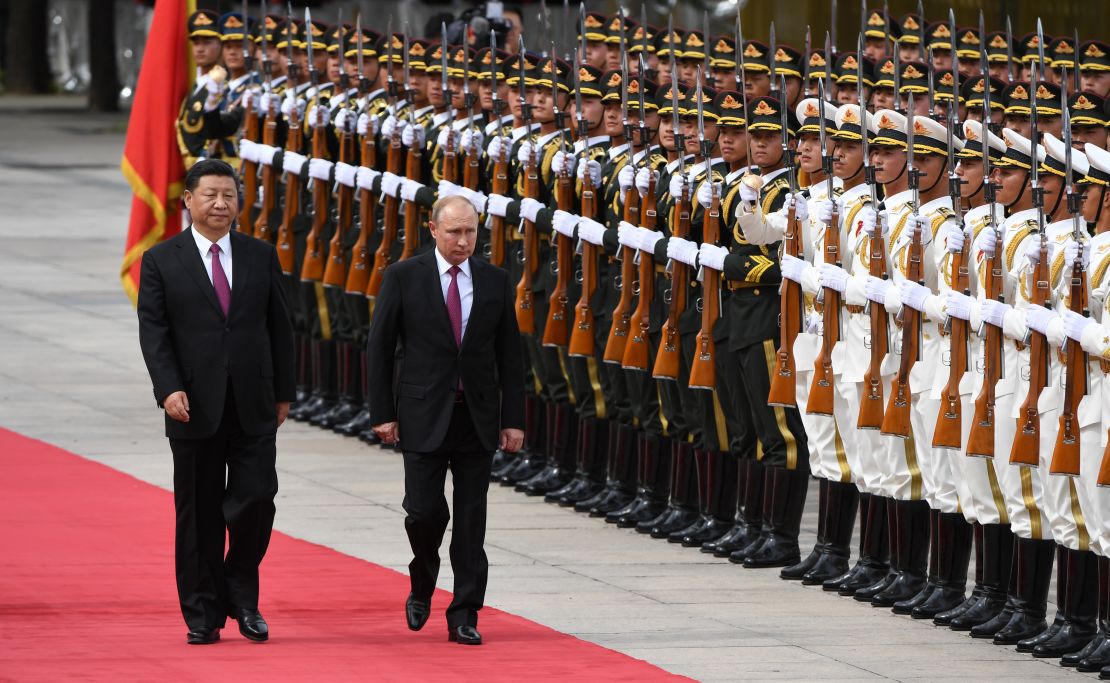Russia's President Vladimir Putin reviews a military honour guard with Chinese President Xi Jinping during a welcoming ceremony outside the Great Hall of the People in Beijing on Friday, June 8.