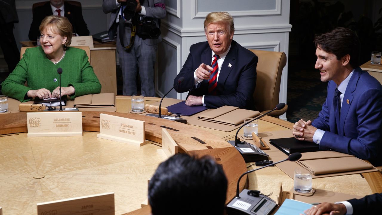 German Chancellor Angela Merkel, President Donald Trump, and Canadian Prime Minister Justin Trudeau participate in a G-7 summit working session, Friday, June 8, 2018, in Charlevoix, Canada. (AP Photo/Evan Vucci)