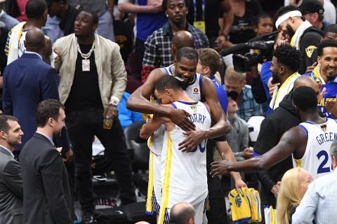 Kevin Durant hugs Golden State teammate Stephen Curry after the game. Durant was named NBA Finals MVP for the second straight season.