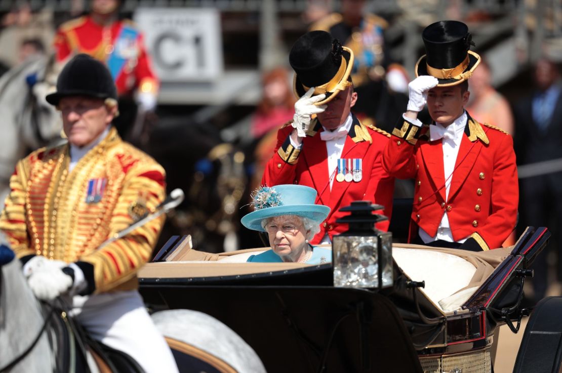 Queen Elizabeth II rides in an open carriage Saturday in the Trooping the Colour parade in London.