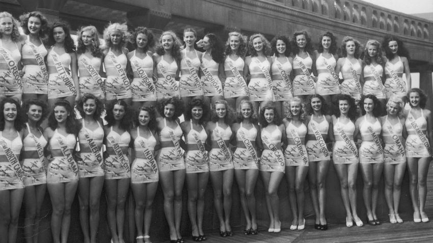 1947:  Contestants in the Miss America pageant pose in two rows, wearing two-piece swimsuits and sashes from their home states, on the boardwalk, Atlantic City, New Jersey.  (Photo by Hulton Archive/Getty Images)
